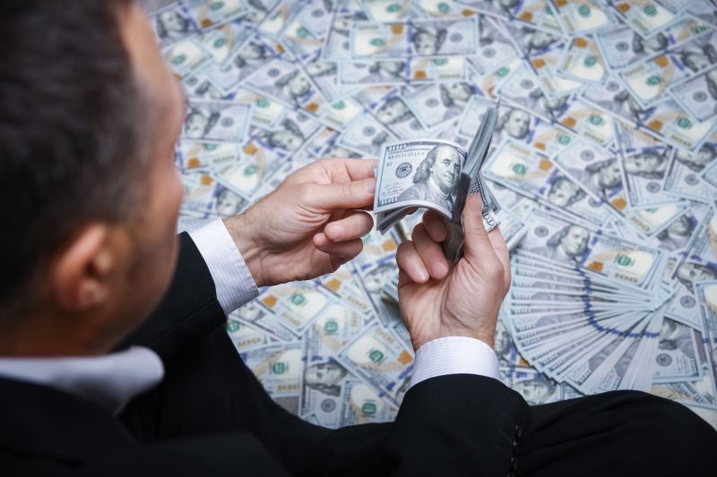 A Happy guy with money in his hands for the development of shopp