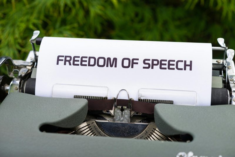 White and Black Paper on Typewriter that says "Freedom of speech"
