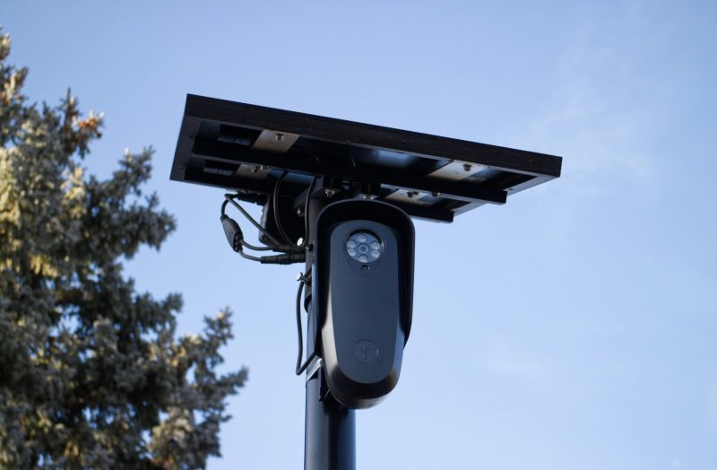A solar-powered outdoor surveillance camera ALPR mounted on a pole, capturing clear day images