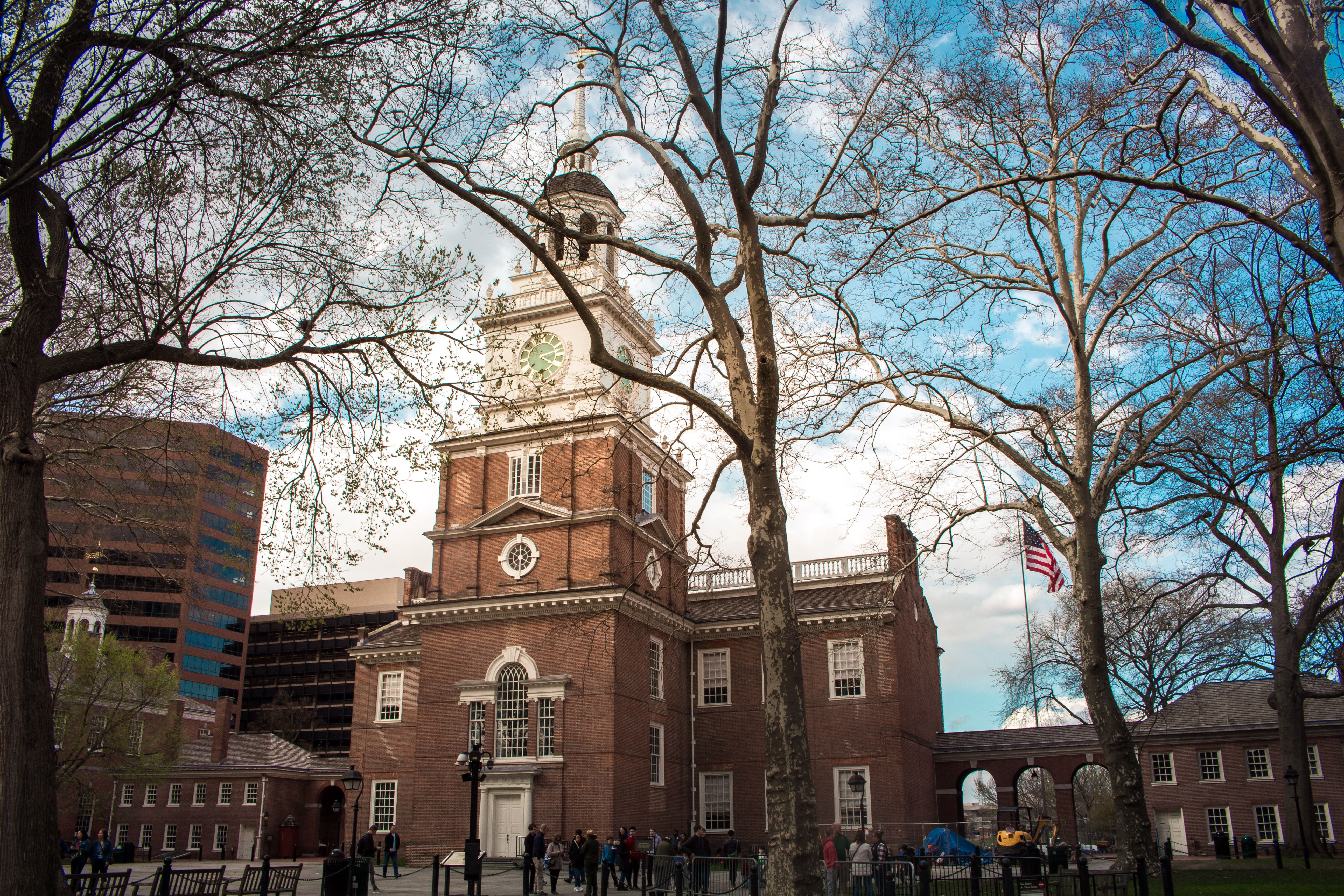 Independence Hall in Philadelphia with a vibrant blue sky and surrounding trees in spring. Independence Hall in Philadelphia with a vibrant blue sky and surrounding trees in spring.