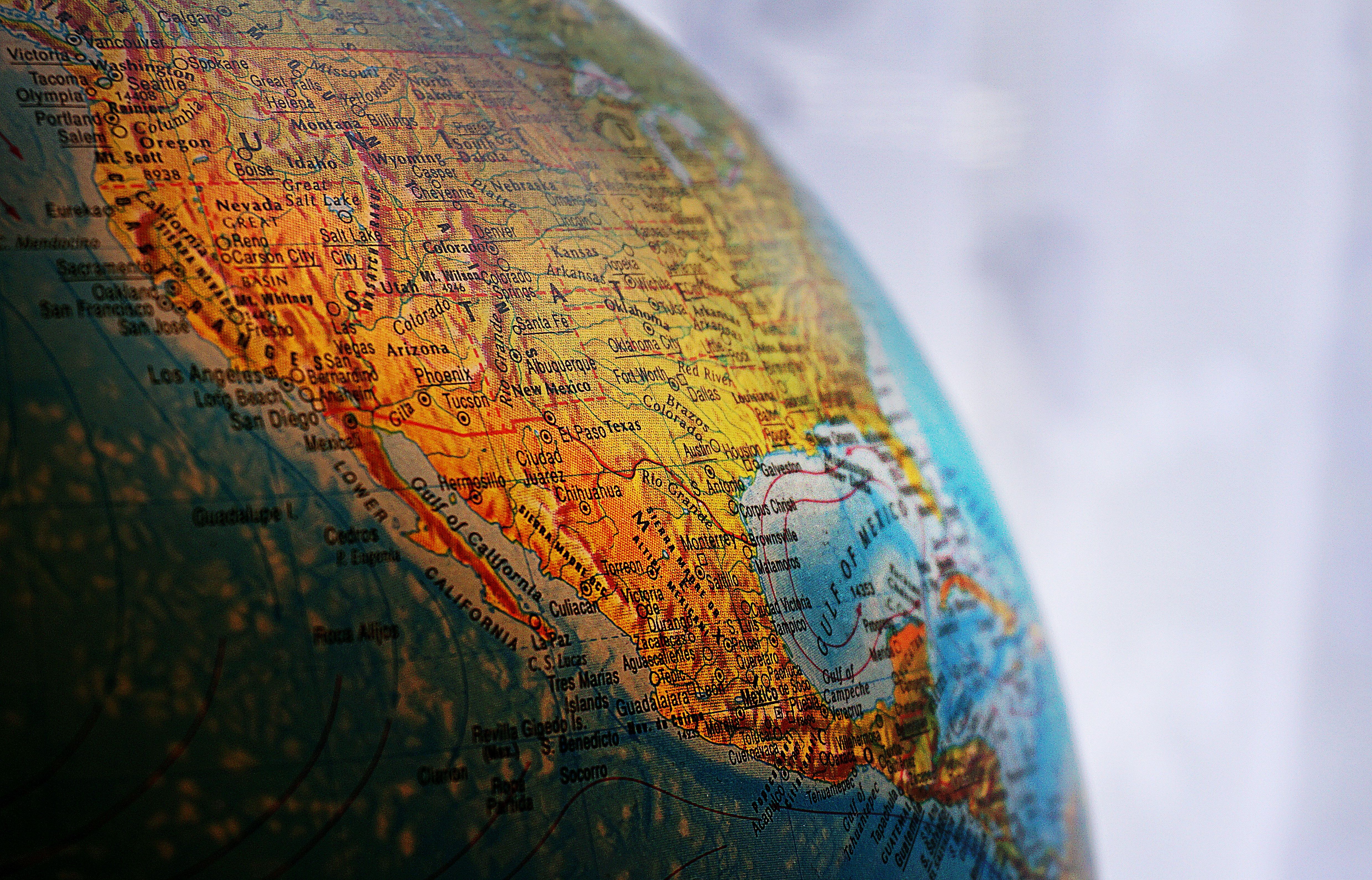 Close-up of a globe highlighting North America, showcasing geography and cartography details. Close-up of a globe highlighting North America, showcasing geography and cartography details.