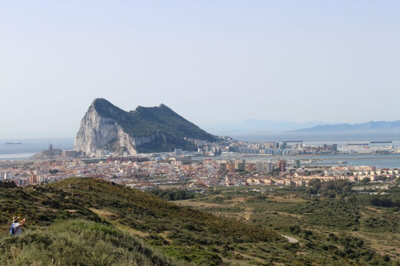 A clear view of the iconic Rock of Gibraltar from a distance, capturing the cityscape and coastal beauty.