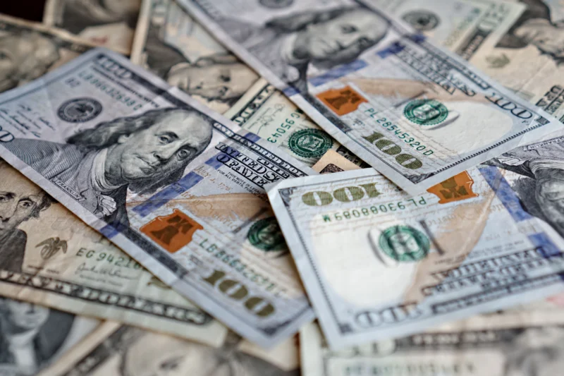 A collection of US dollar bills featuring different denominations.
